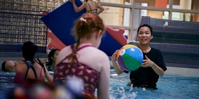 University of Waterloo therapeutic recreation student in a pool with children