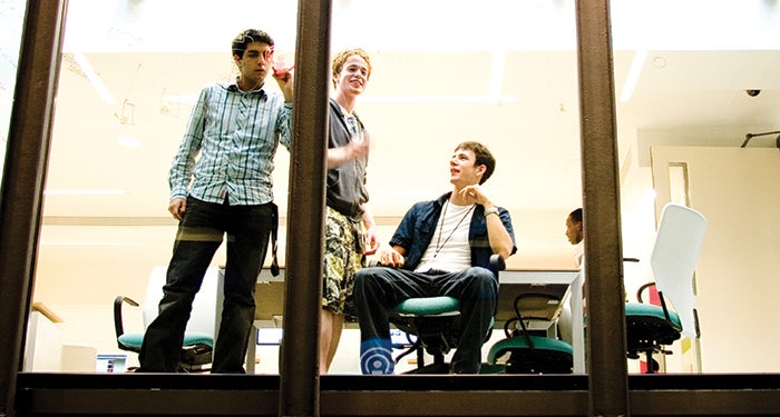 Students solve problems on a glass window