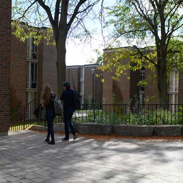 Two students walking outside Village 1