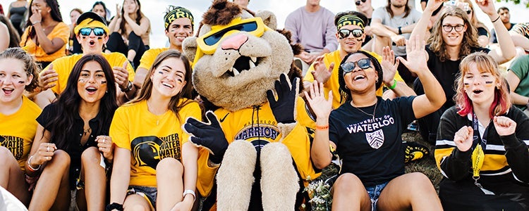 Students posing with a King Warrior at orientation.