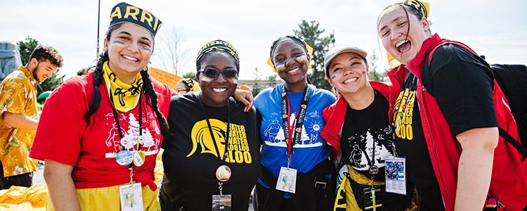 Five students smiling together.