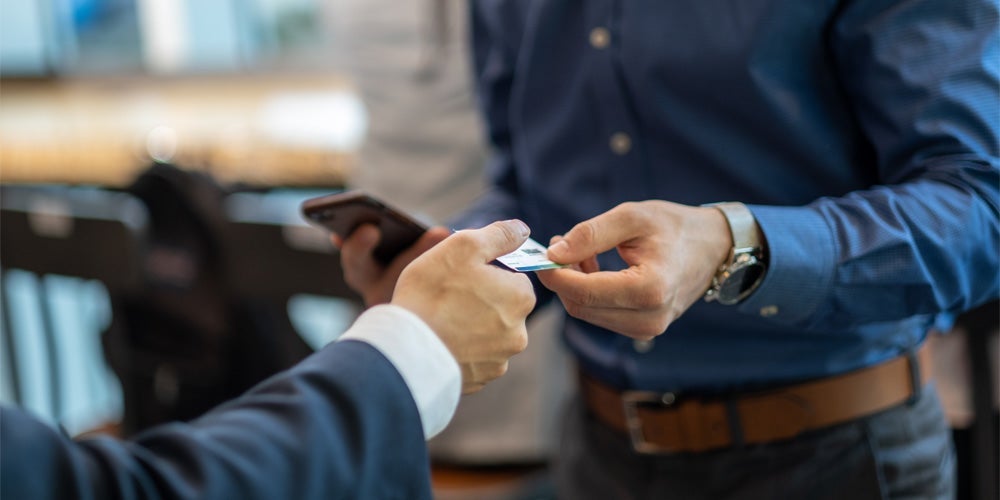 close up of hands passing credit card