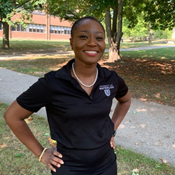 International Recruitment Specialist Akua standing by a path. 