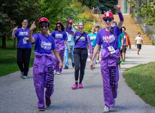 Engineer students in purple outfits at orientation