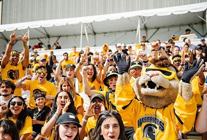 Students showing Warrior pride at a Waterloo game