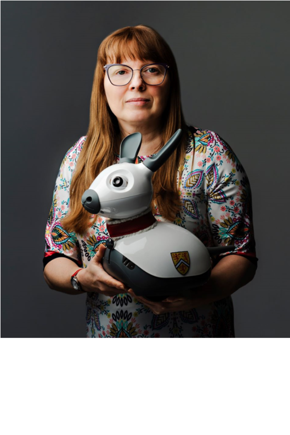 Kerstin Dautenhahn holding a robotic animal 
