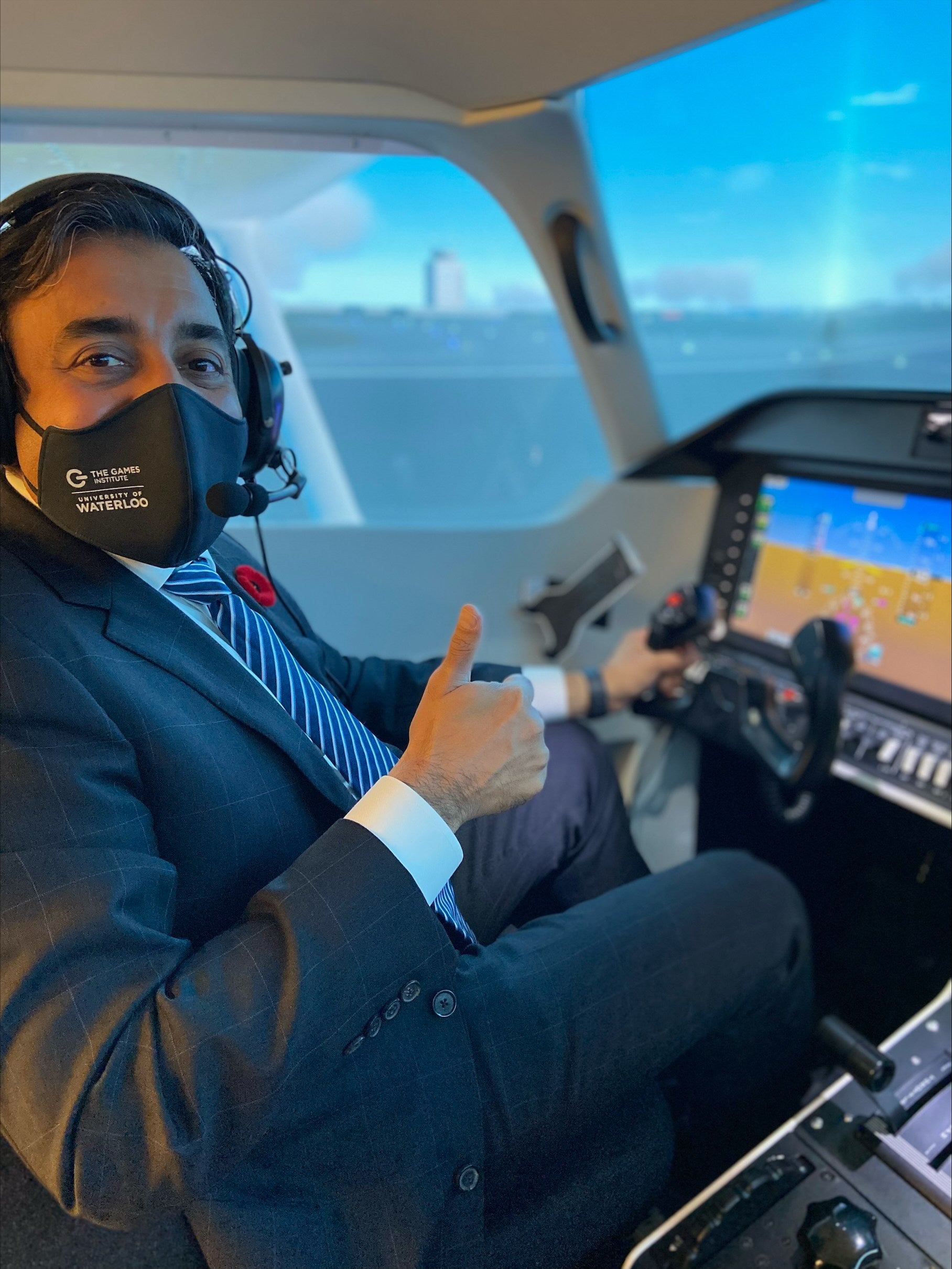 Minister Khaleed in a flight simulator with a face mask on.