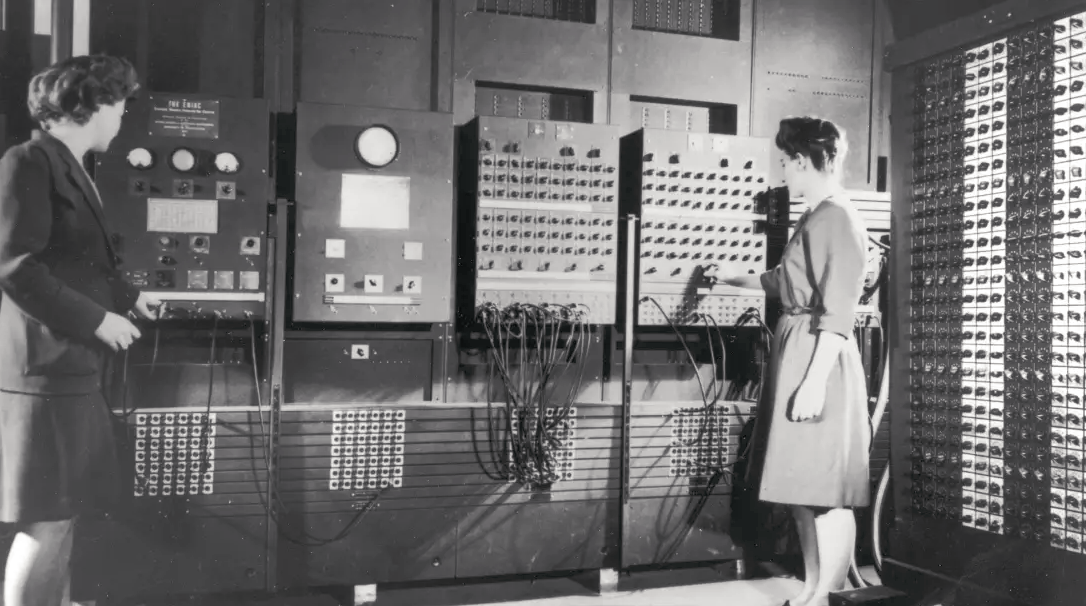 Two women infront of ENIAC