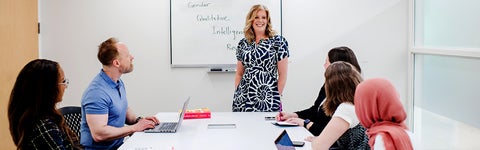 Dr. Diana Parry leading small group discussion in seminar room.