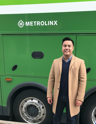 Edward standing in front of a Metrolinx sign