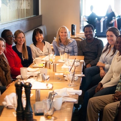 Ten members of the lab around a table for lunch. 