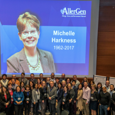 Members of AllerGen stand next to a picture of Michelle Harkness