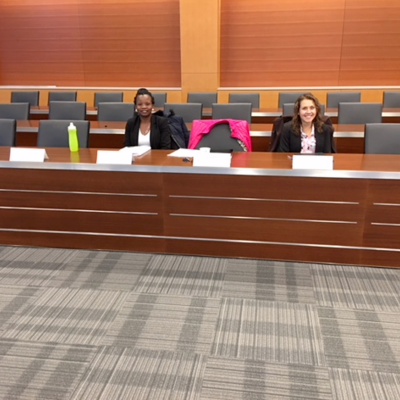 Elizabeth Opiyo Onyango and Andrea Rishworth seated at the board room table.
