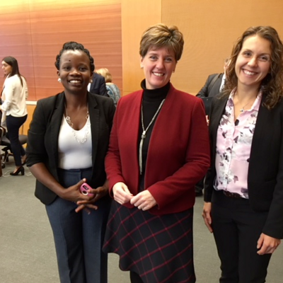 Two PhD students from the GoHelP lab smile for a picture with the Hon. Marie-Claude Bibeau
