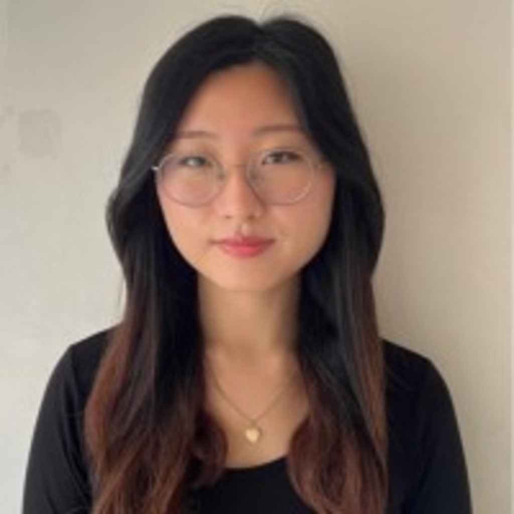 young asian woman with mid-length hair wearing round glasses and a black shirt