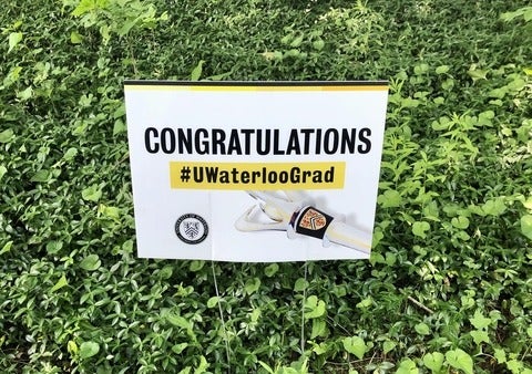 Congratulations Waterloo grad sign poking out of grass