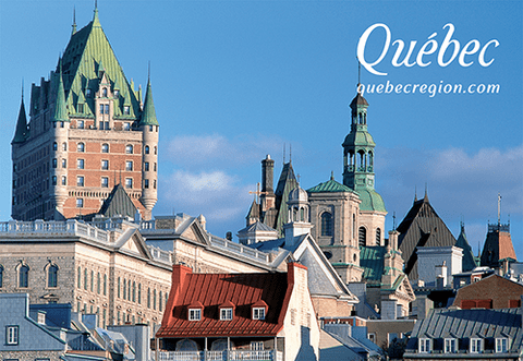 Landscape of rooftops against a blue sky in Quebec City.