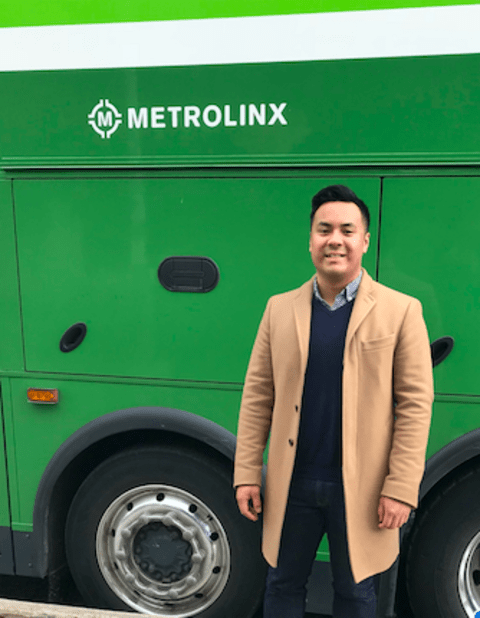 Edward standing in front of a Metrolinx sign