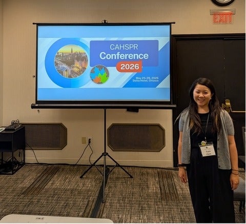Tara in front of her presentation at CAG
