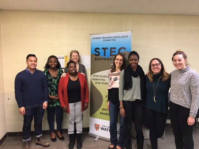 GoHelP lab members stand together in front of a Student Teaching Excellence Comittee banner