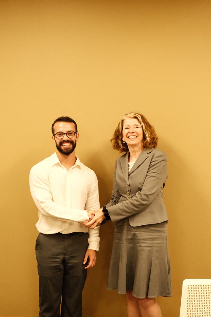 Susan and Rodrigo shaking hands 