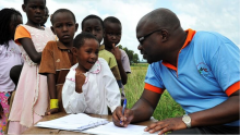 Health worker talking with school children in Kenya