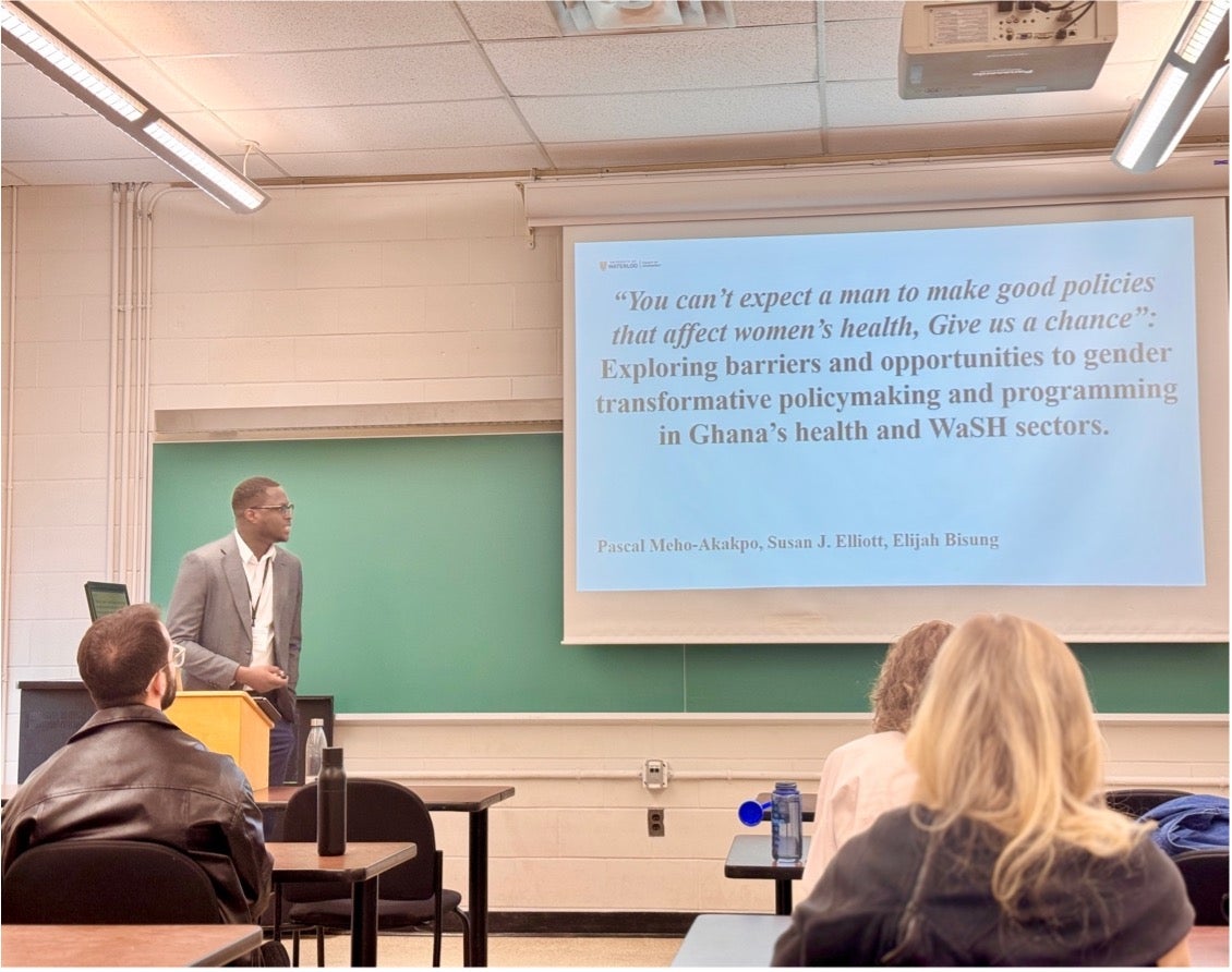 pascaal presenting in front of projector screen