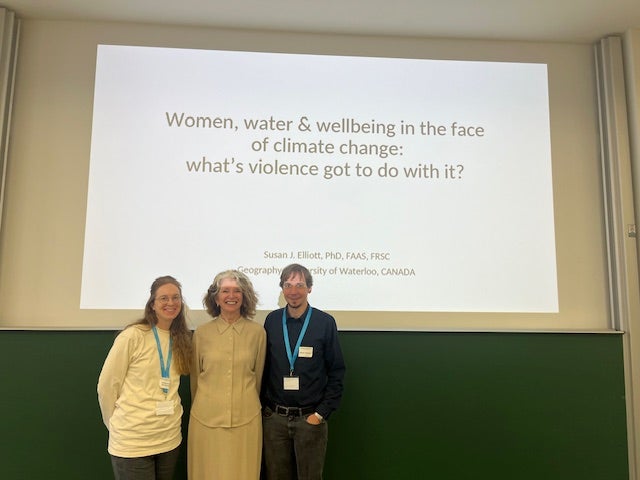 Susan Elliott in front of presentation at the international Conference on Conflict and Violence with two others