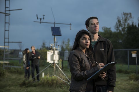 Students standing in front of a weather station