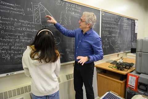 Claude and student working at a blackboard