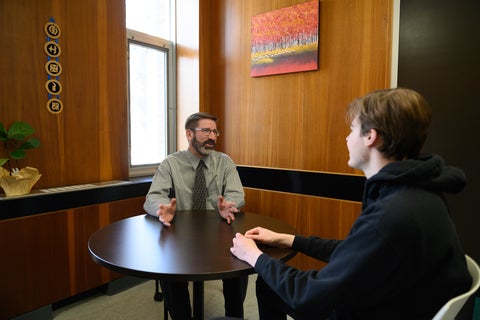 Alan Anthony speaking with student