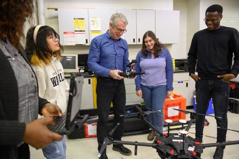 Students with faculty in a lab