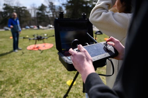 Student holding a drone controller