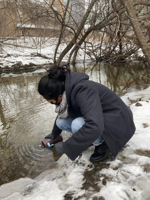 A student collecting water sample