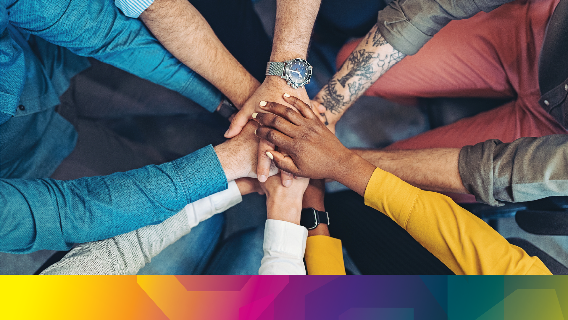 Diverse peoples all putting their hands in together