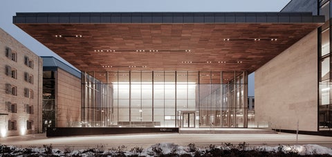 The outside of the CIGI building, lit up at night.