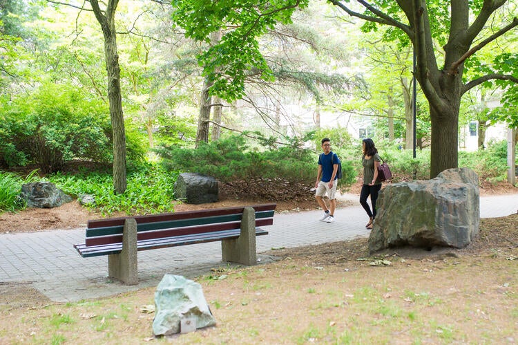 Two students walking in a the Peter Russell rock garden