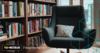 Comfortable chair with pillow beside a shelf of books