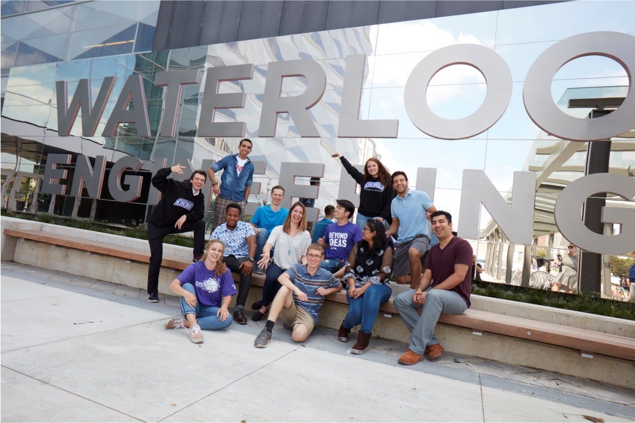 A group of students with the Waterloo Engineering sign