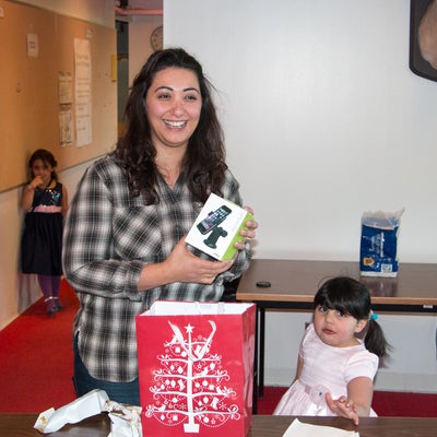 Photo of Asmaa opening her gift
