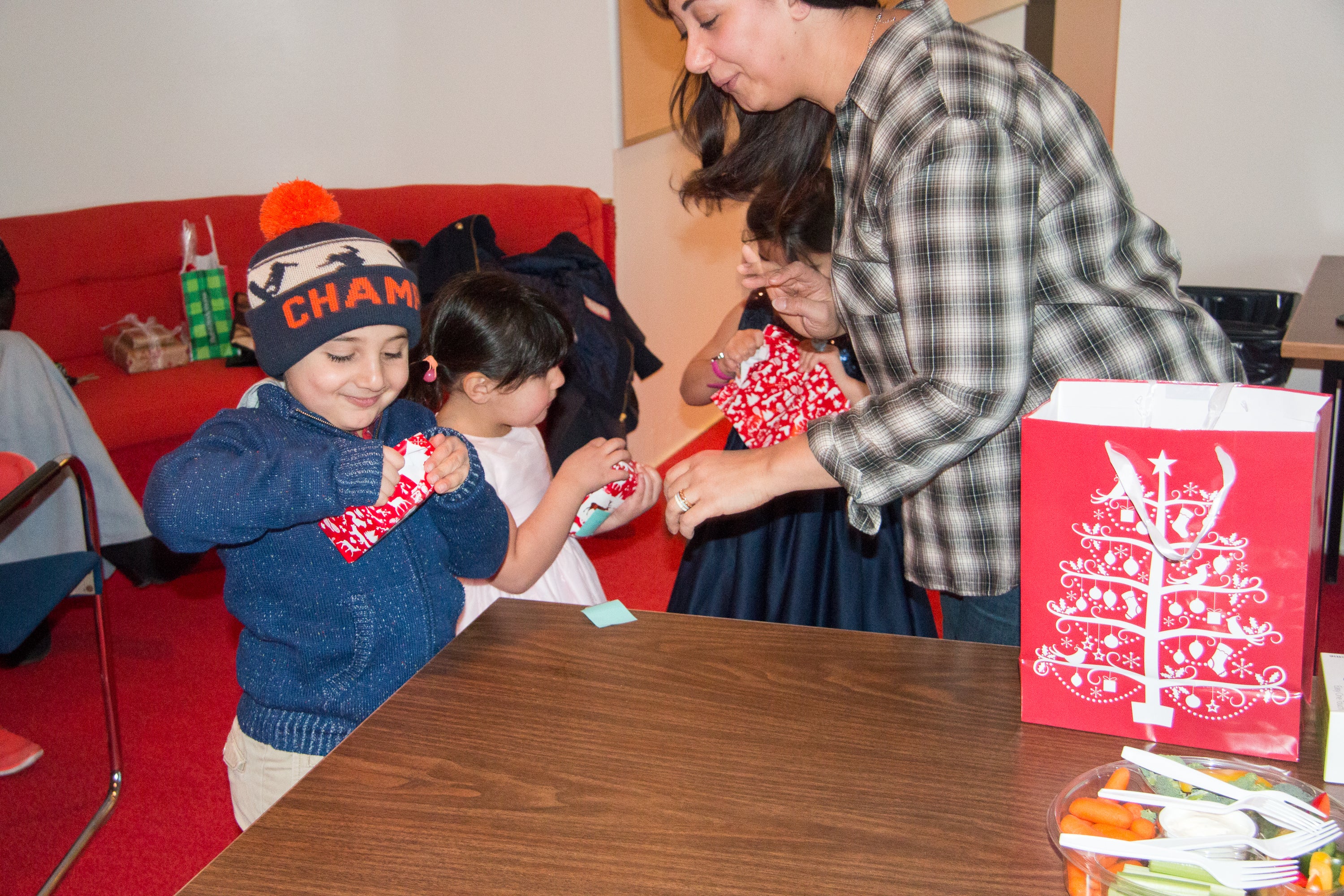 Photo of asmaa's kids opening their gifts