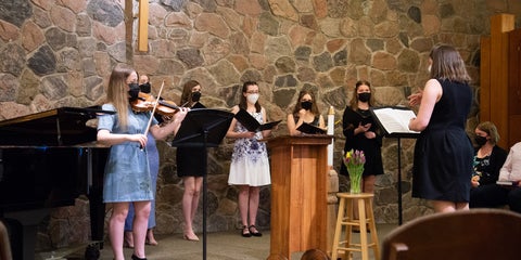students singing in the chapel