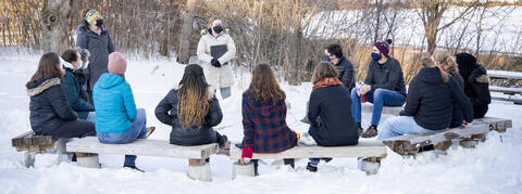 Students attending a serivce outside in the snow