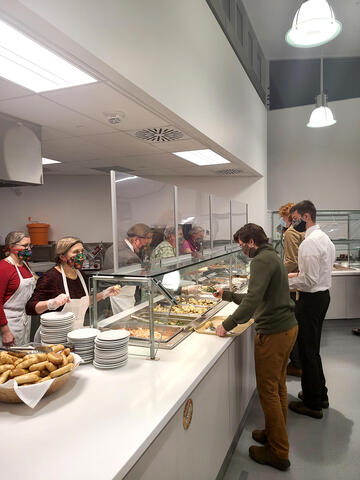 students are served dinner by Grebel staff