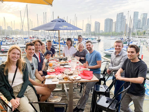 Alumni eating at lakeside restaurant in Vancouver