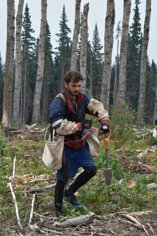 Samuel Farkas in tree planting gear in the woods