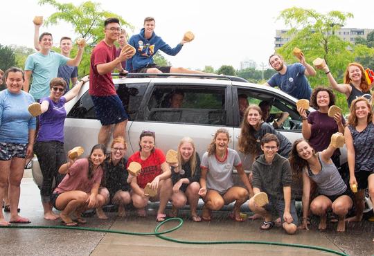 Upper-year students washing a car at the free car wash that they held during Orientation Week.