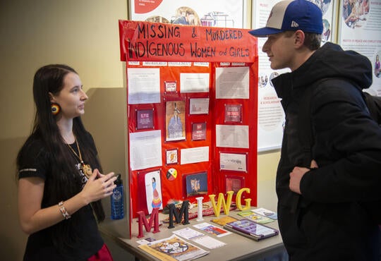 A PACS student speaks with another student about MMIWG