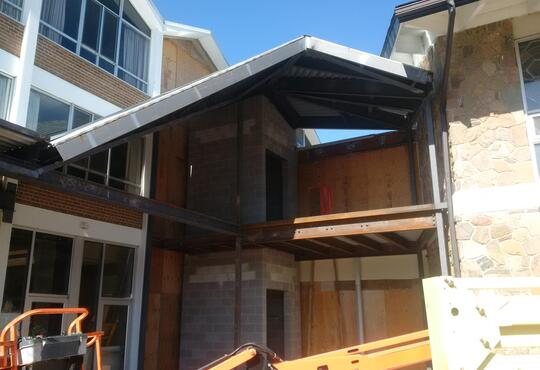 The steel roof between the dining room and chapel is installed