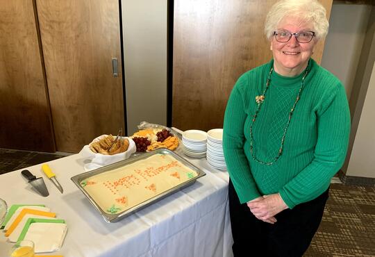 Judy Dyck smiles with a celebratory cake